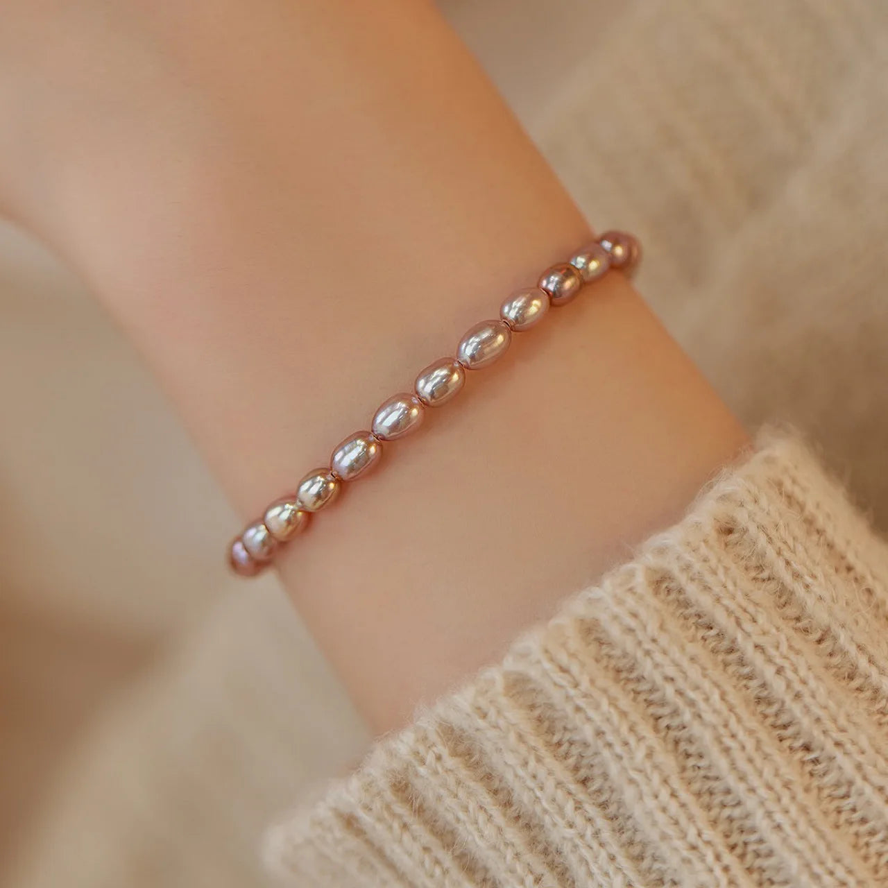 Pearl bracelet on a wrist with a blurred background